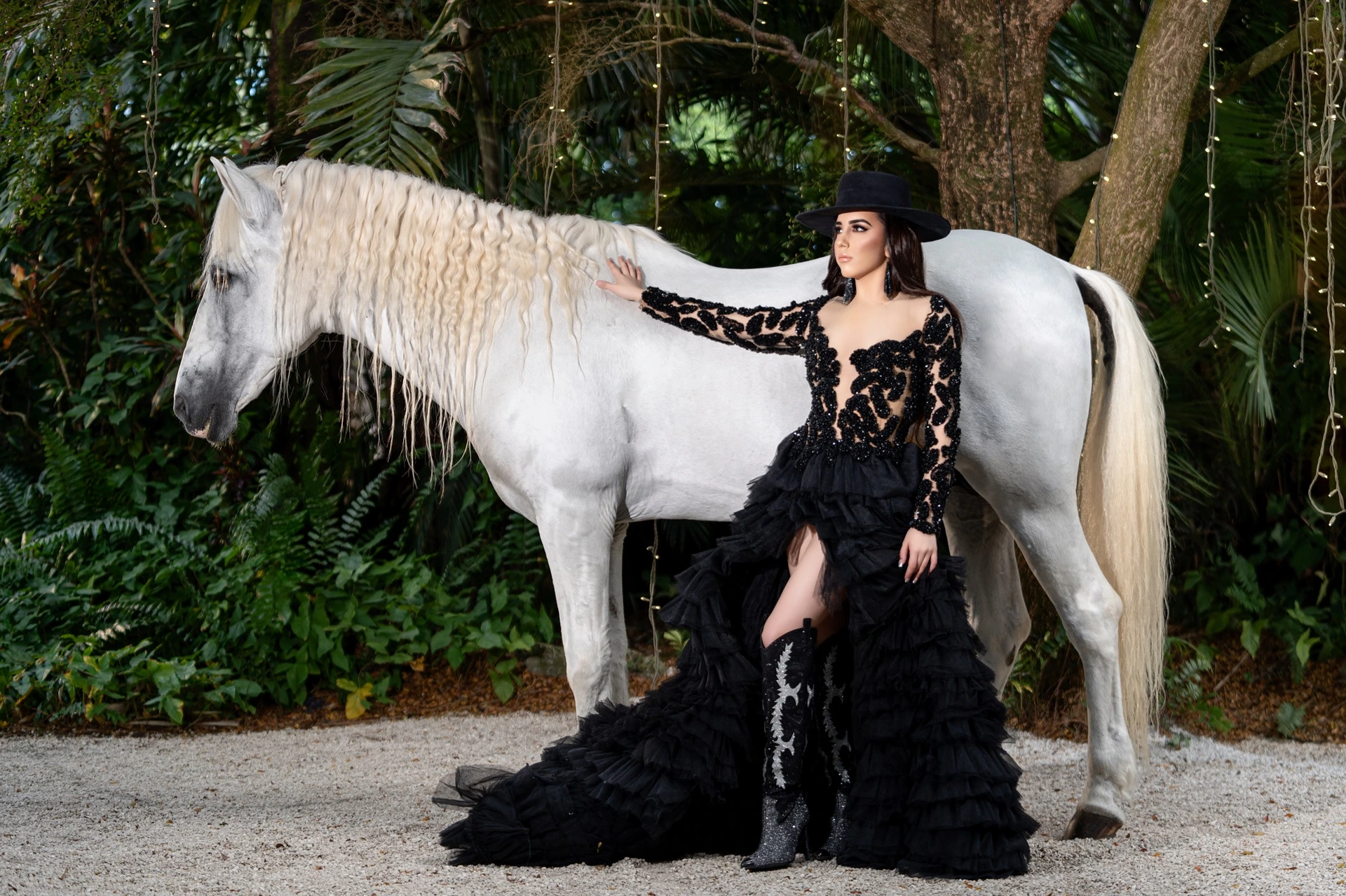 Quinceañera in a white gown with a horse