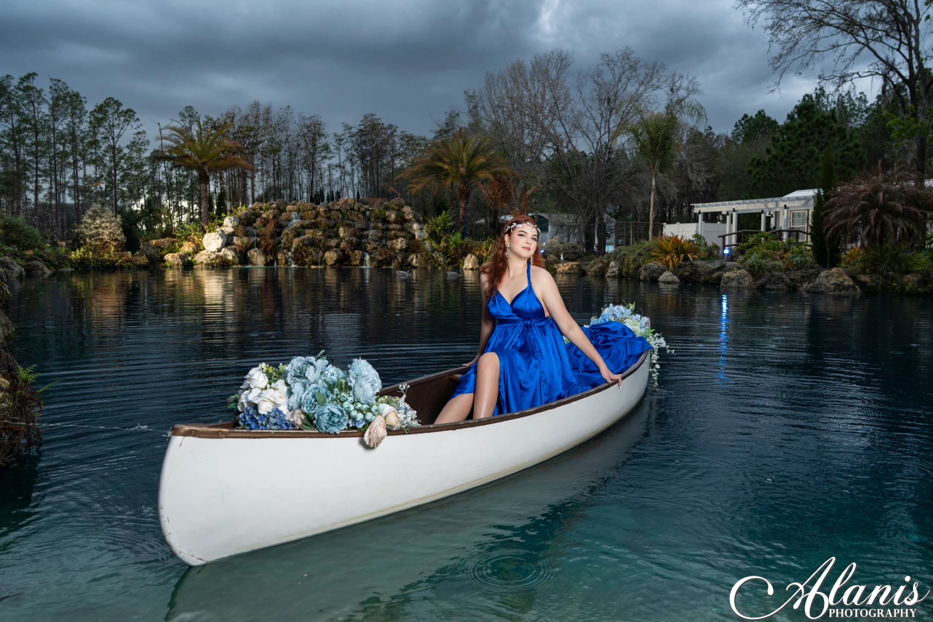 Quinceañera in a blue gown aboard a boat