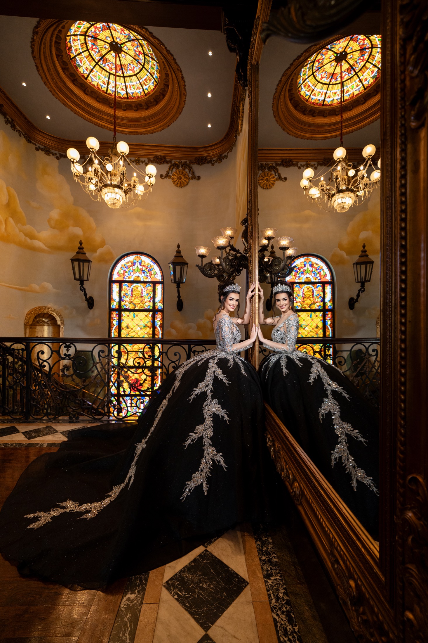 Two quinceañeras in coordinated black gowns