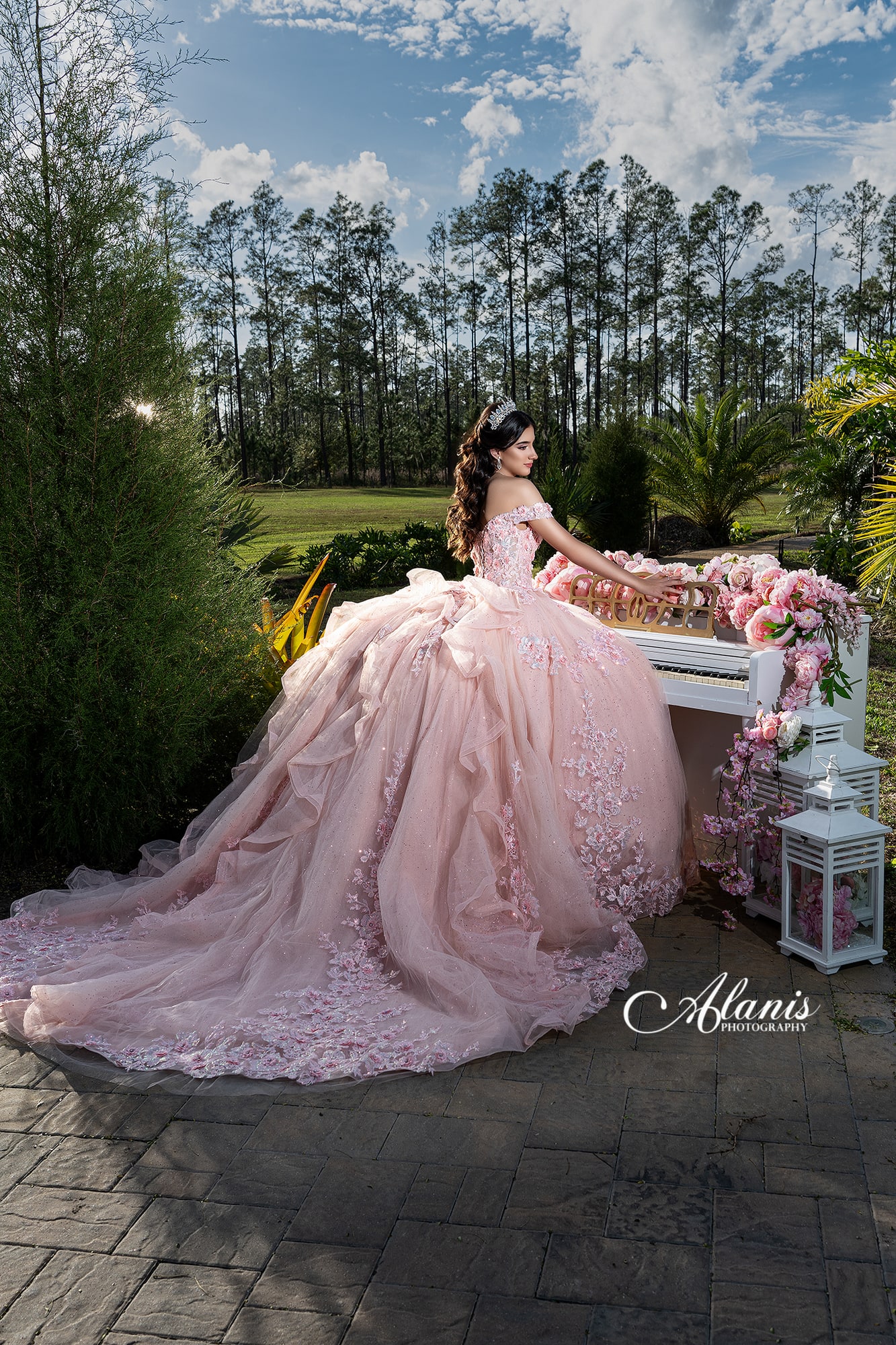 Quinceañera in a pink gown at an outdoor celebration