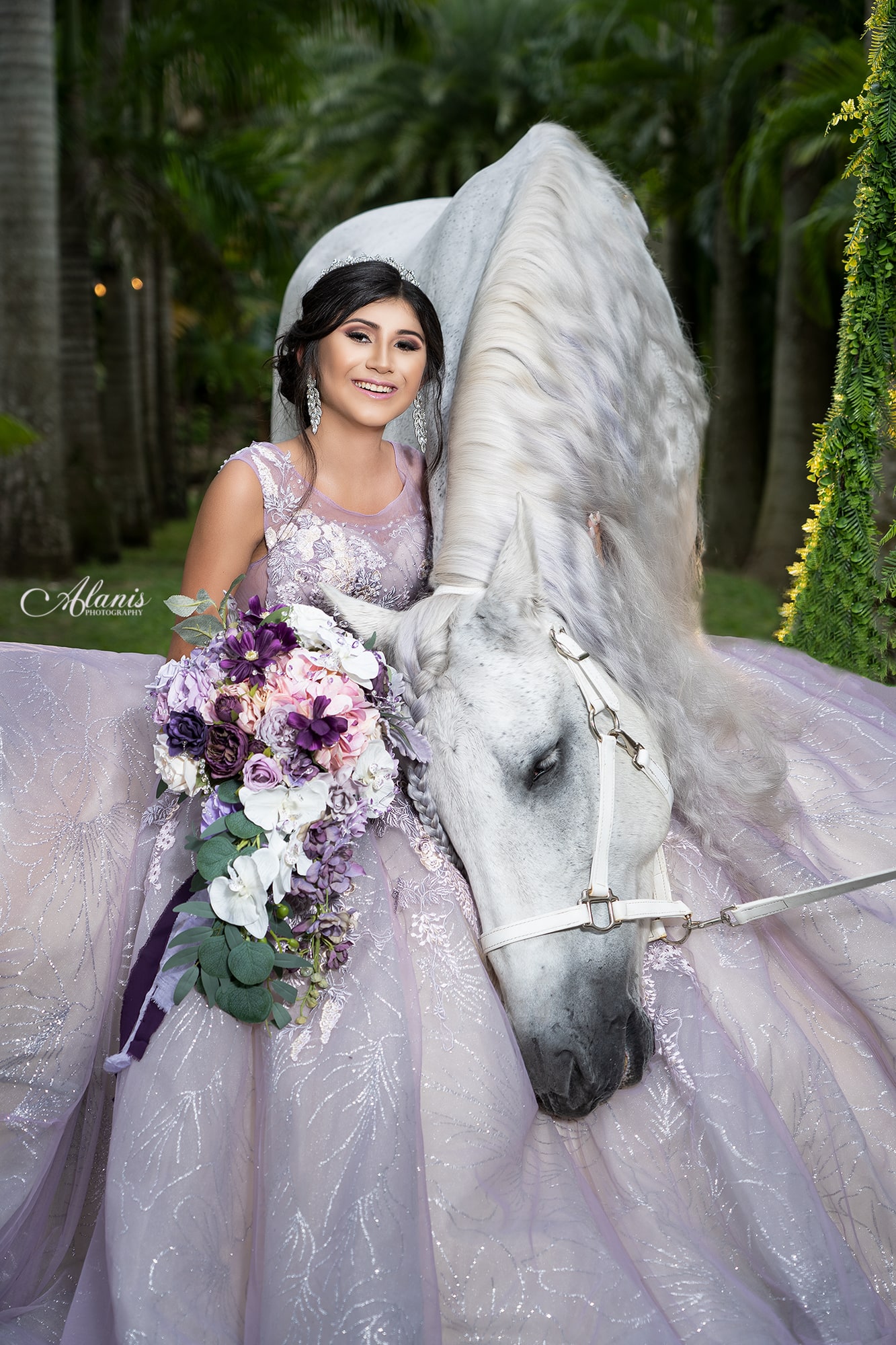 Quinceañera in a white gown with a horse