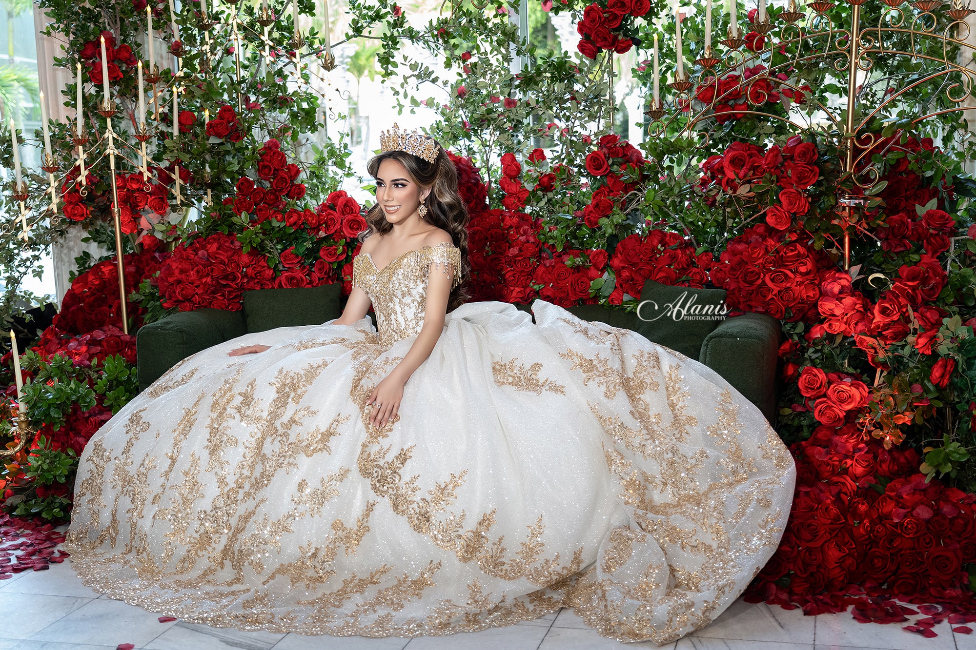 White and gold quinceañera gown in a red rose garden