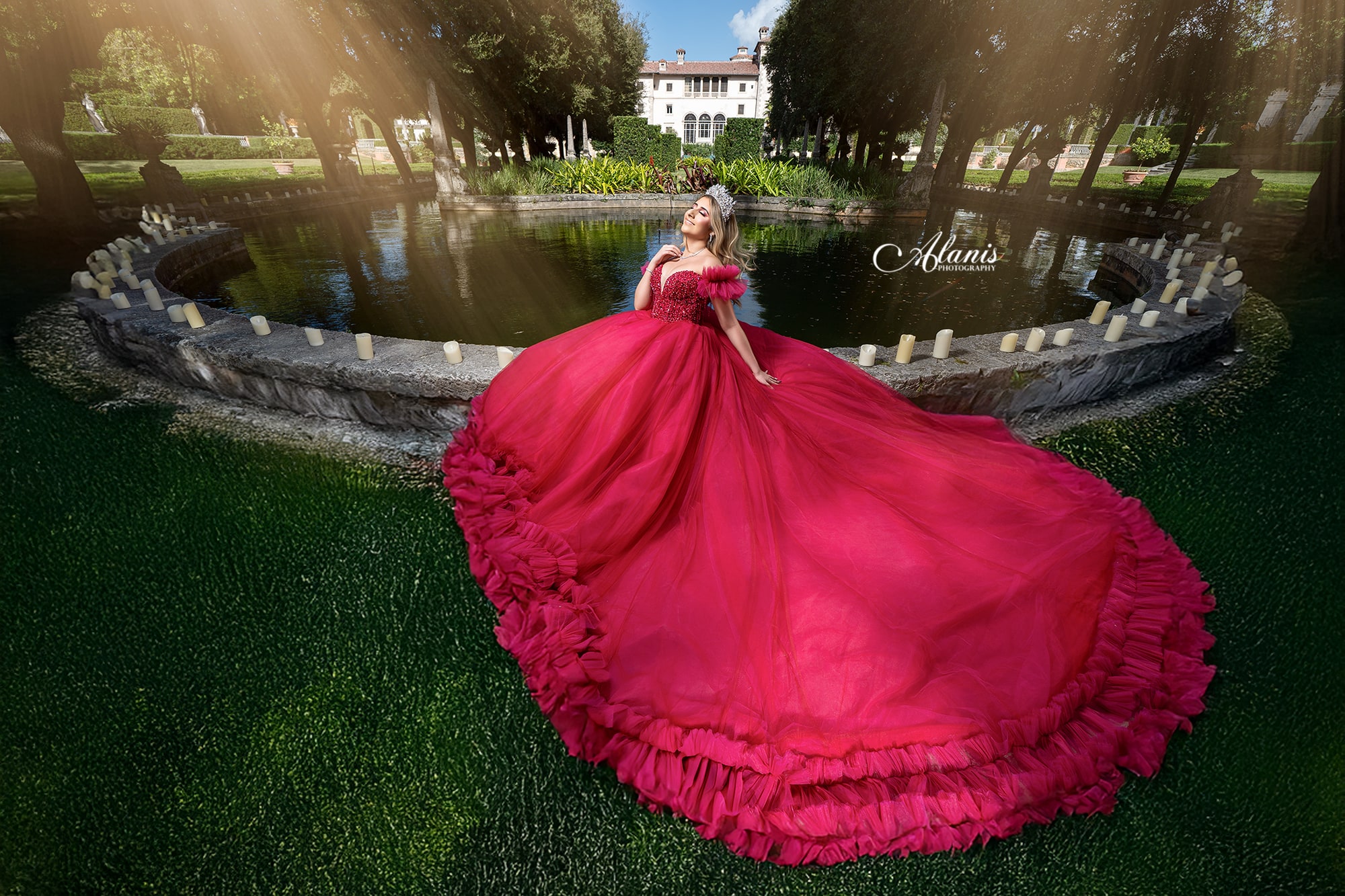 Red quinceañera gown spread across a garden staircase