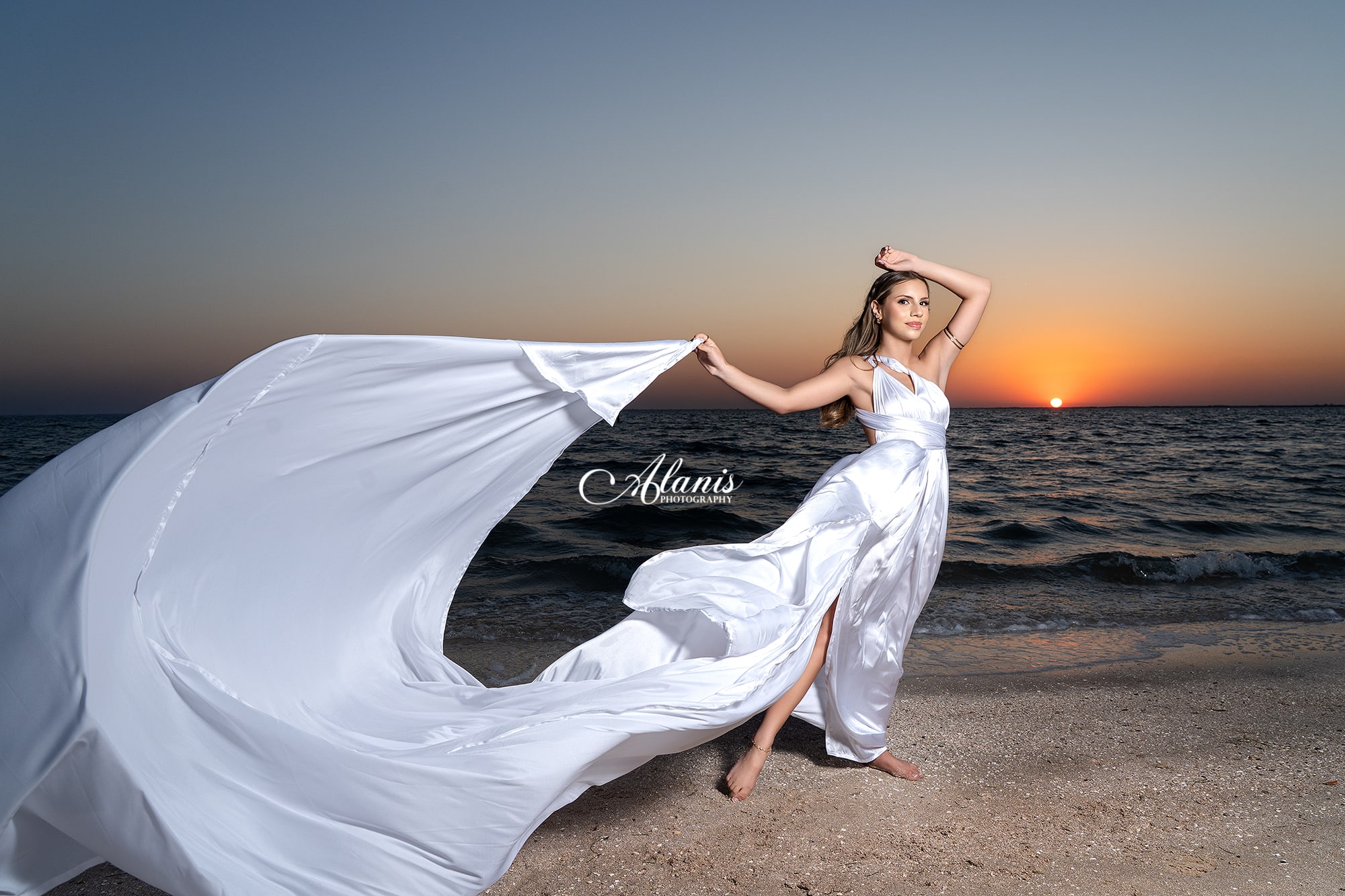 Flowing white quinceañera gown at sunset