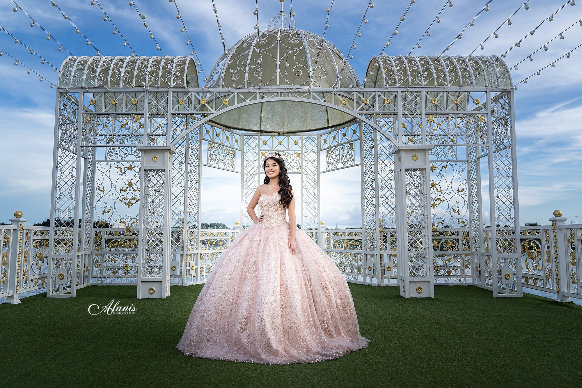 Blush quinceañera gown at a glass conservatory