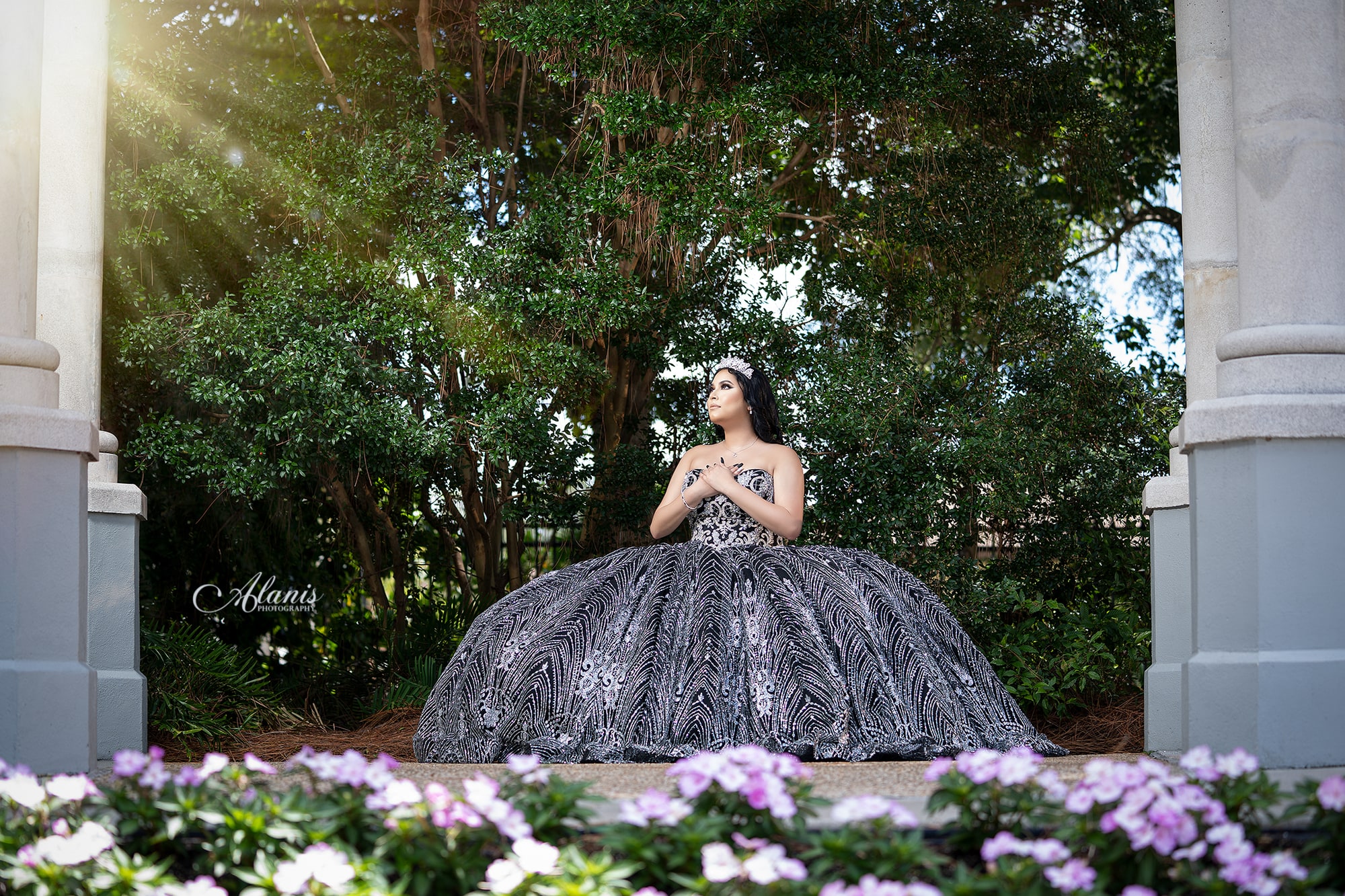 Black and silver quinceañera gown in a garden