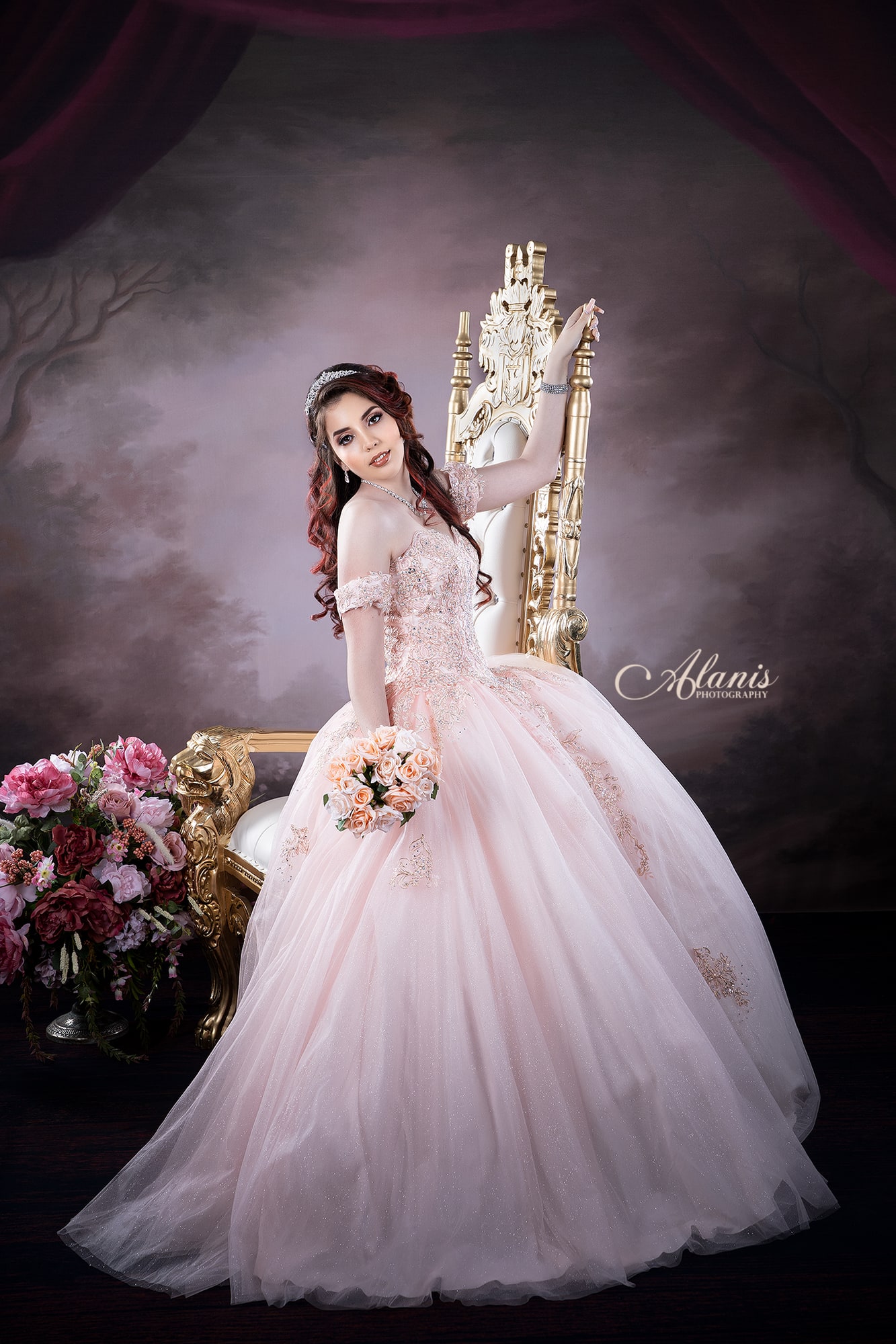 Quinceañera in a pink gown in a studio portrait