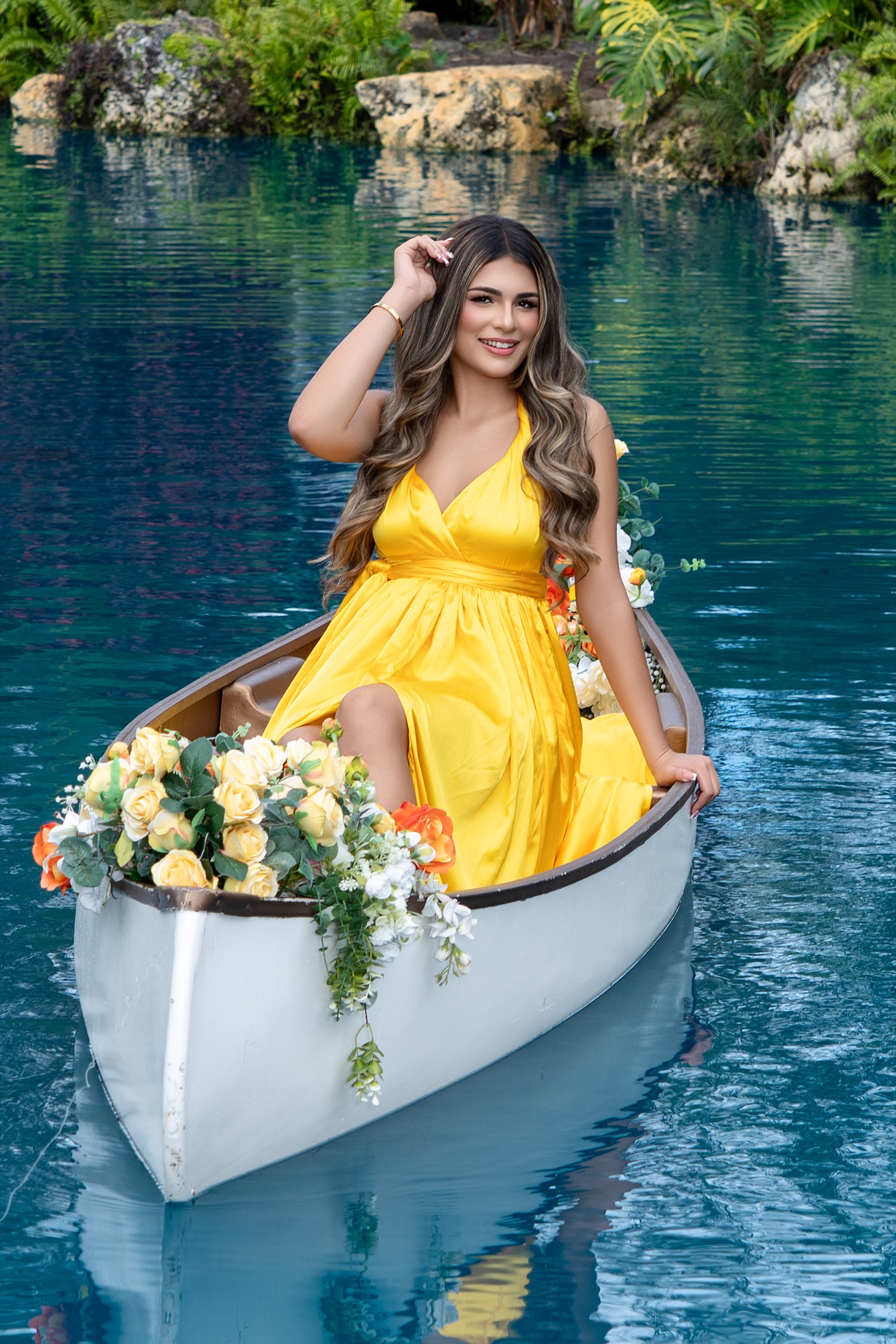 Quinceañera in a green gown on a staircase