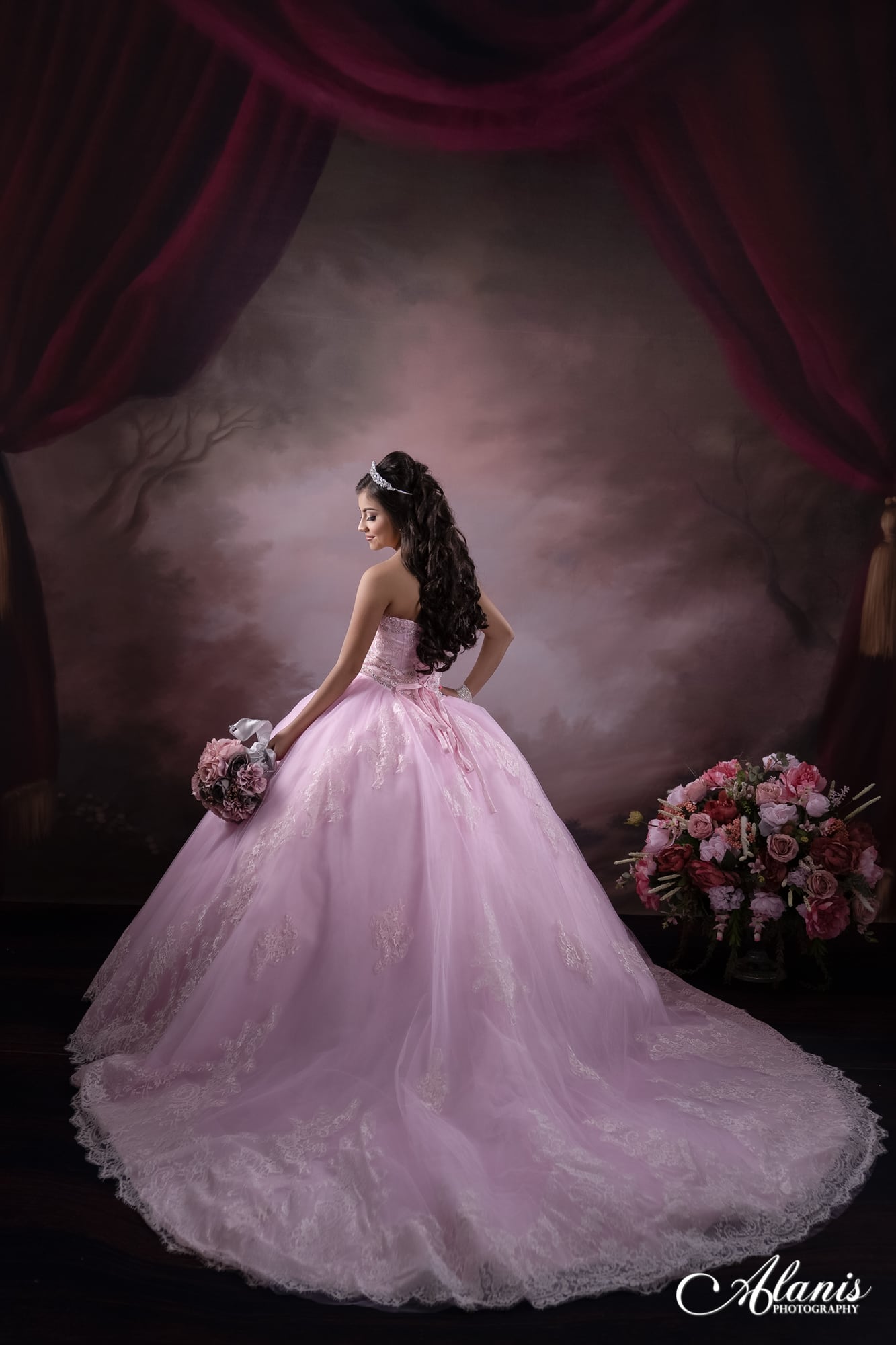 Pink quinceañera gown in a dramatic fine-art studio portrait