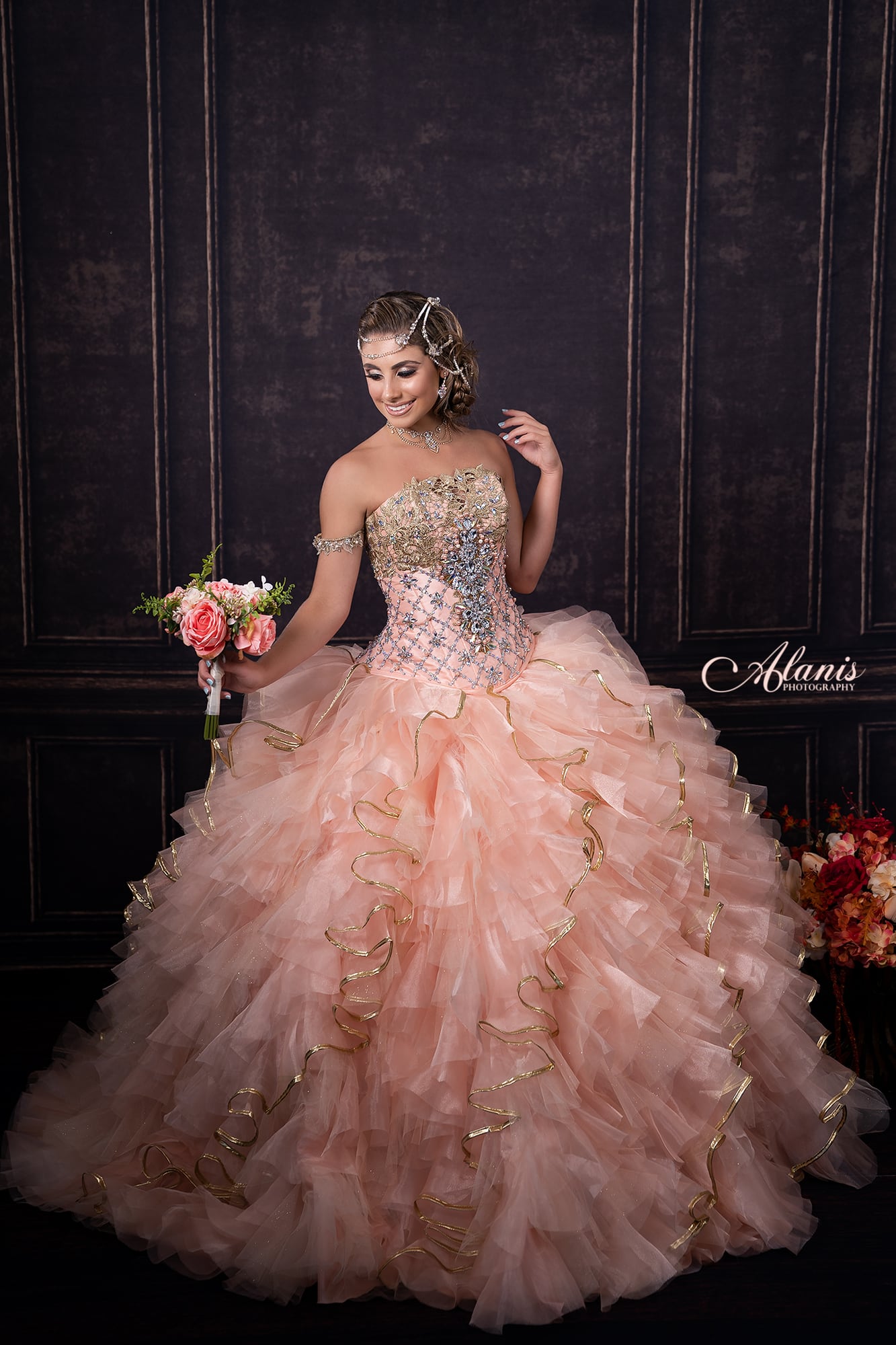 Quinceañera in a rose ruffle gown photographed in the studio