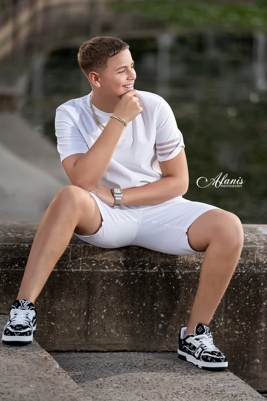 XV for Him outdoor portrait in a white outfit